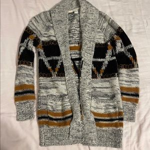 Grey, black, and burnt orange cardigan.